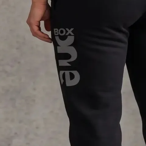 Box One-logo ned ad venstre ben på joggers i kulsort